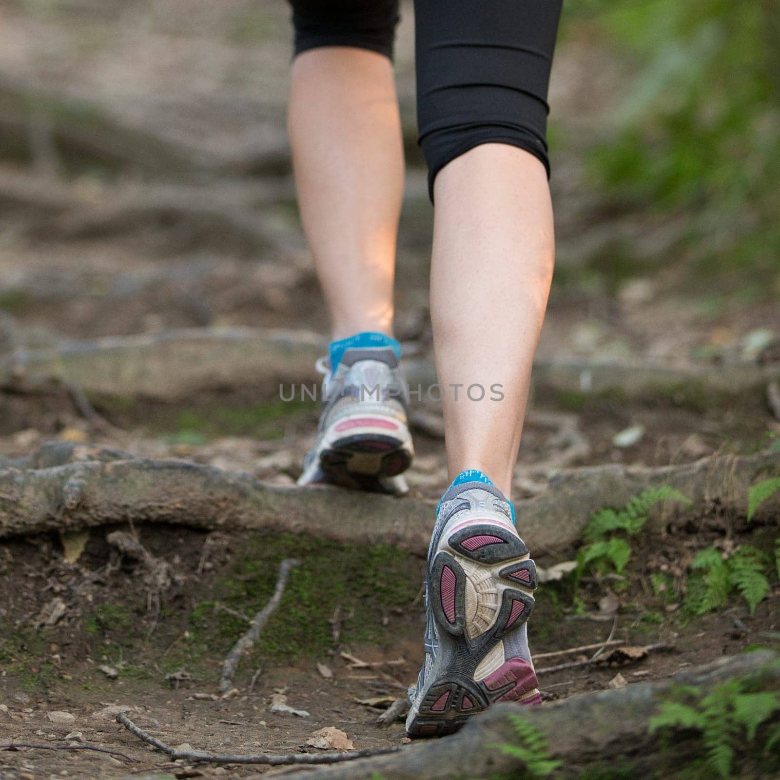 Woman jogging during outdoor workout in nature. Weight Loss. Healthy lifestyle consept.