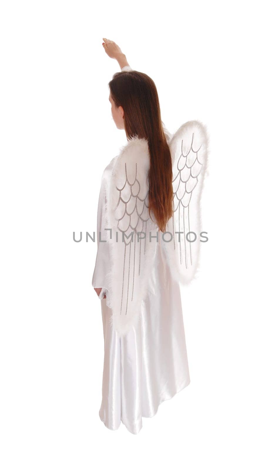 An angel in a long white satain dress with wings and long brown hair.standing in profile with arm raised, isolated for white background..