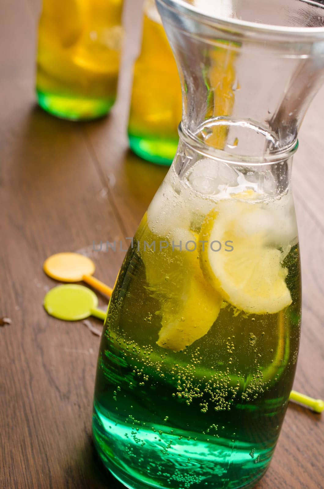 Rainbow colored cocktail on a wooden table