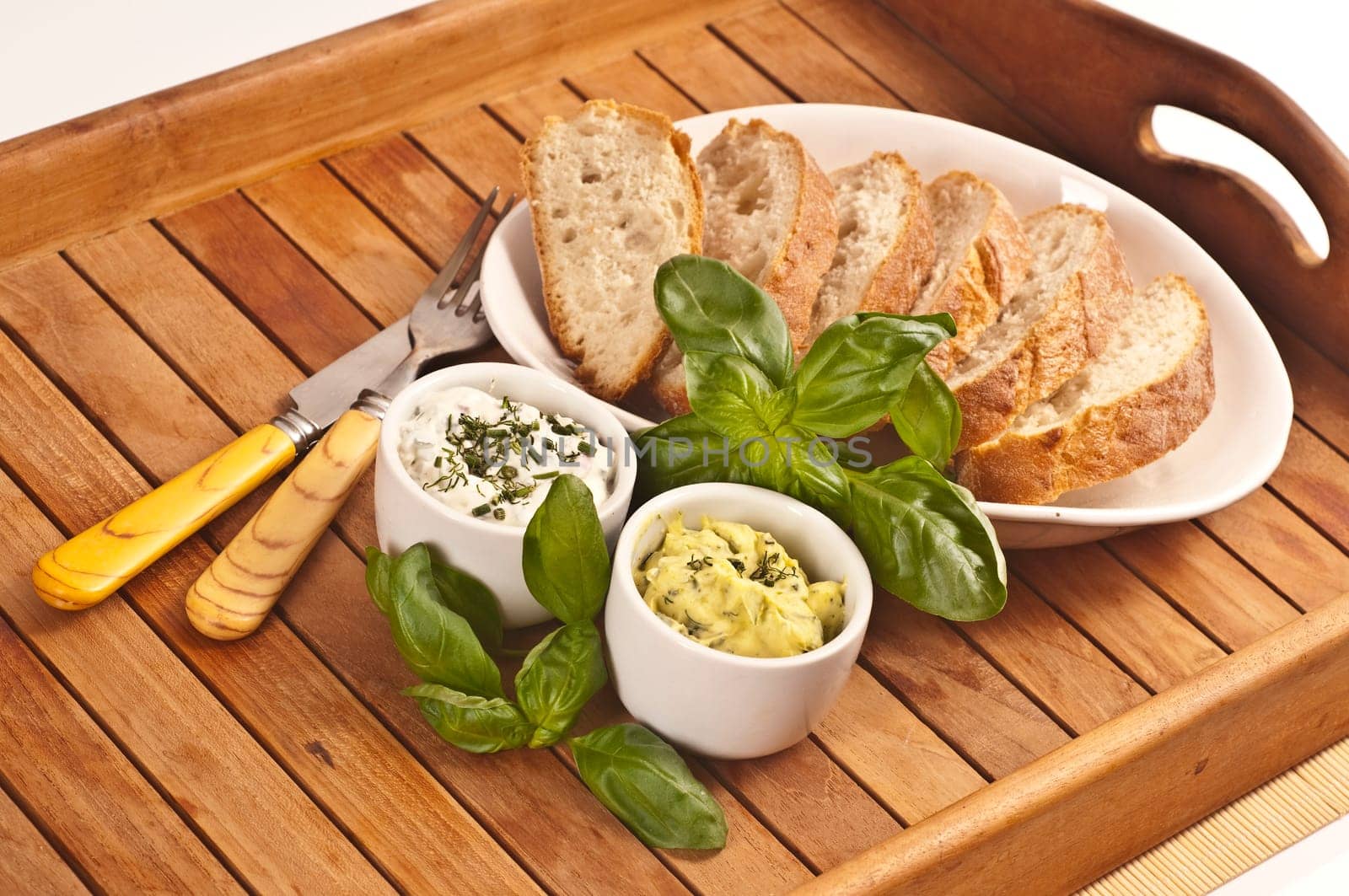 Fresh bread with herb butter and herb quark