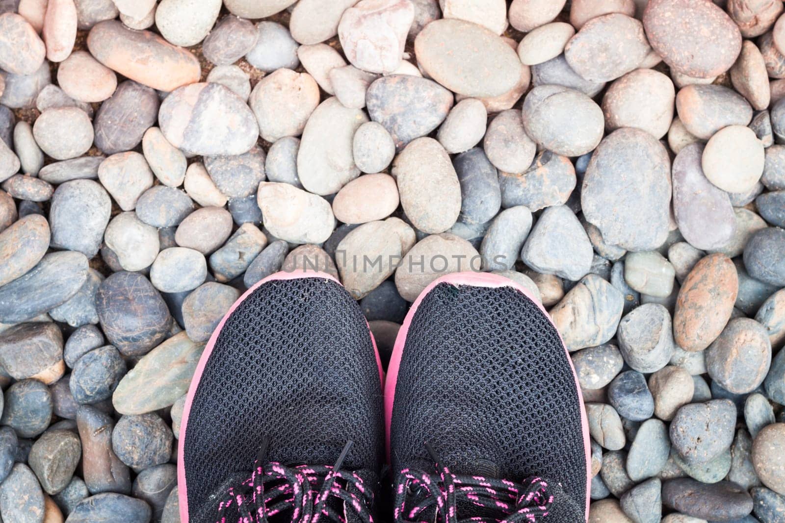Running shoes in home garden on pebbles, stock photo