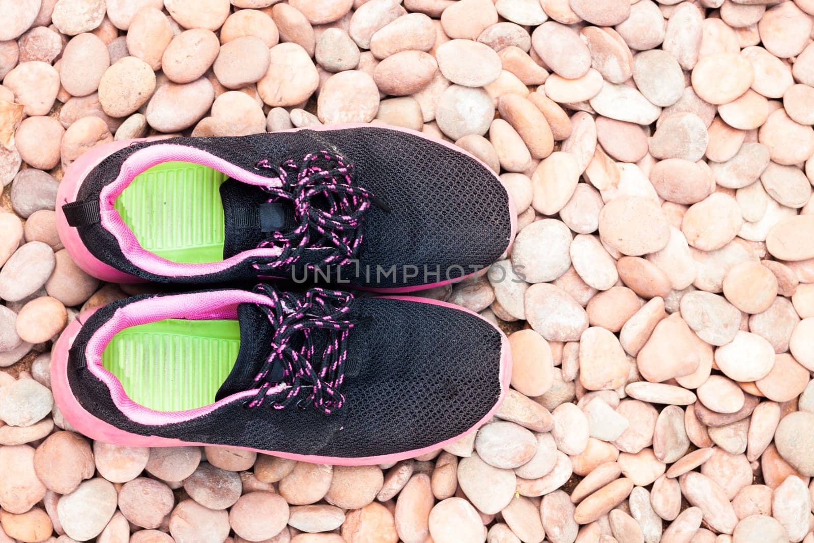 Running shoes in home garden on pebbles, stock photo