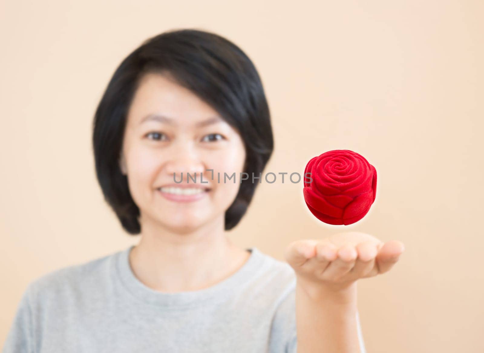 Red rose of ring box on woman hand, stock photo