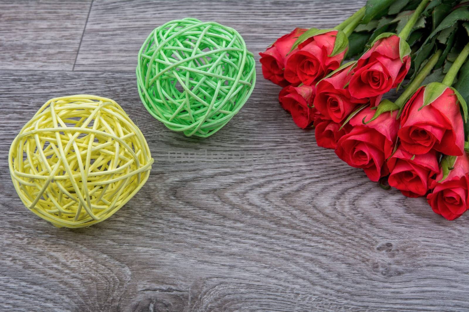 Red roses on a grey wooden background