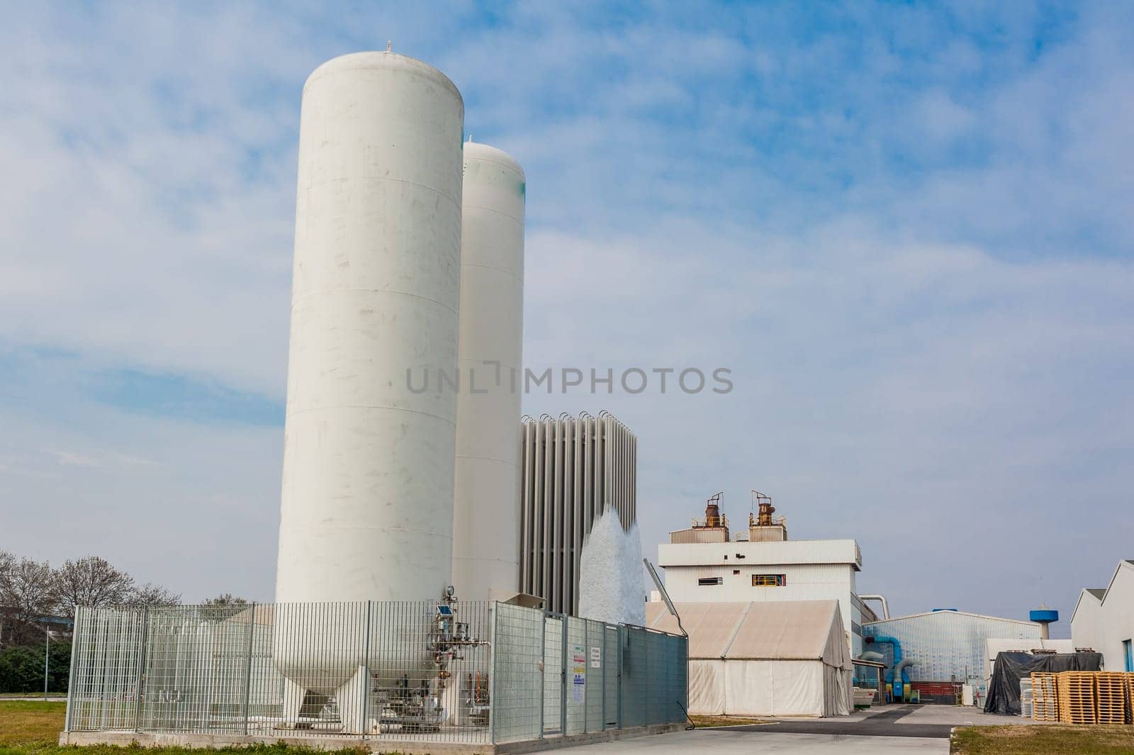 Liquid oxygen plant,tanks and heat exchange coils,the background a factory