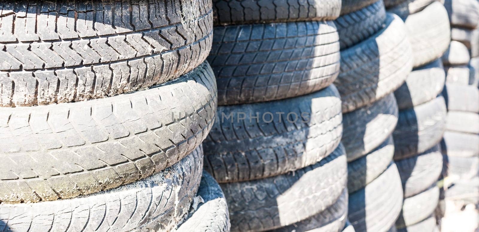 Old used tires stacked with high stacks