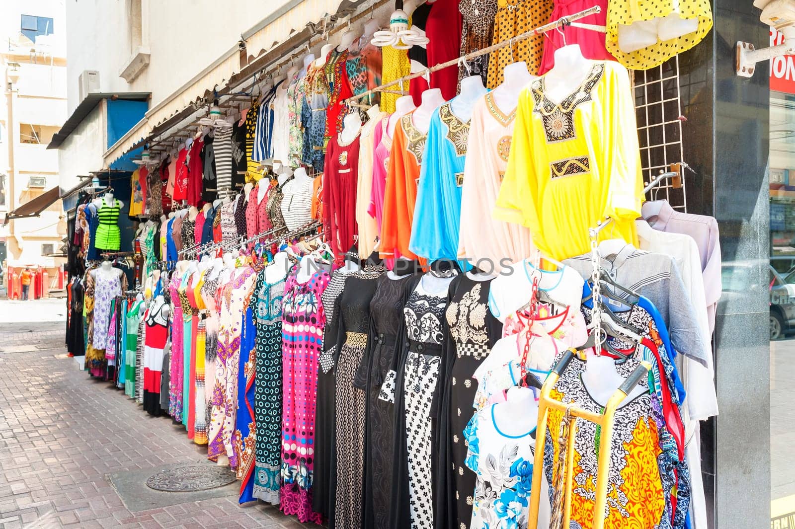Many Indian style clothes for sale at an outdoor market