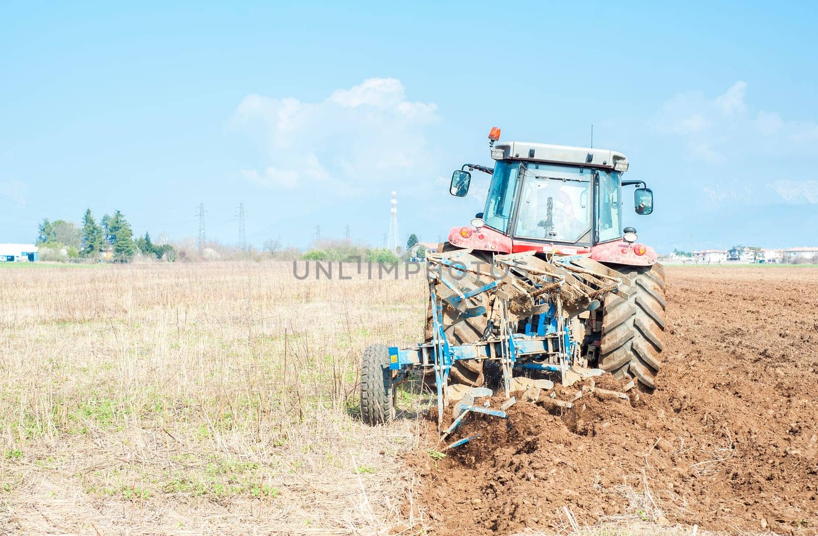Agricultural work.  Tractor plowing the stubble field