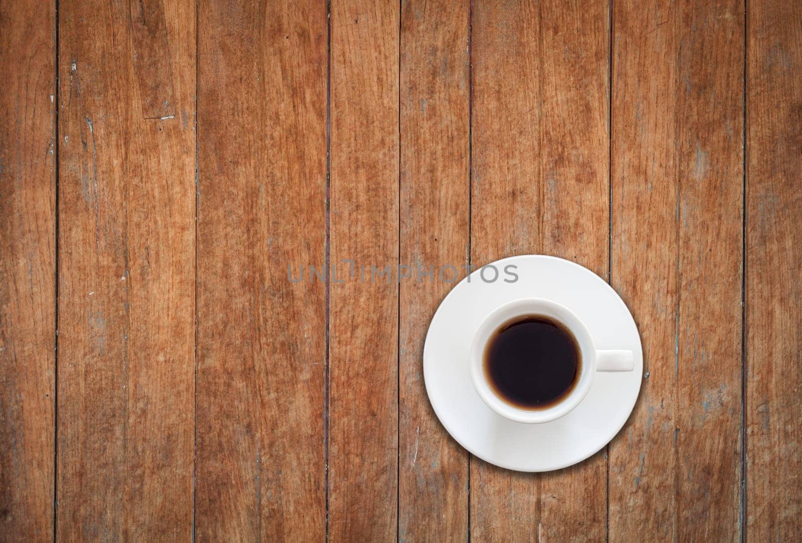 Top view of white coffee cup on wooden background, stock photo