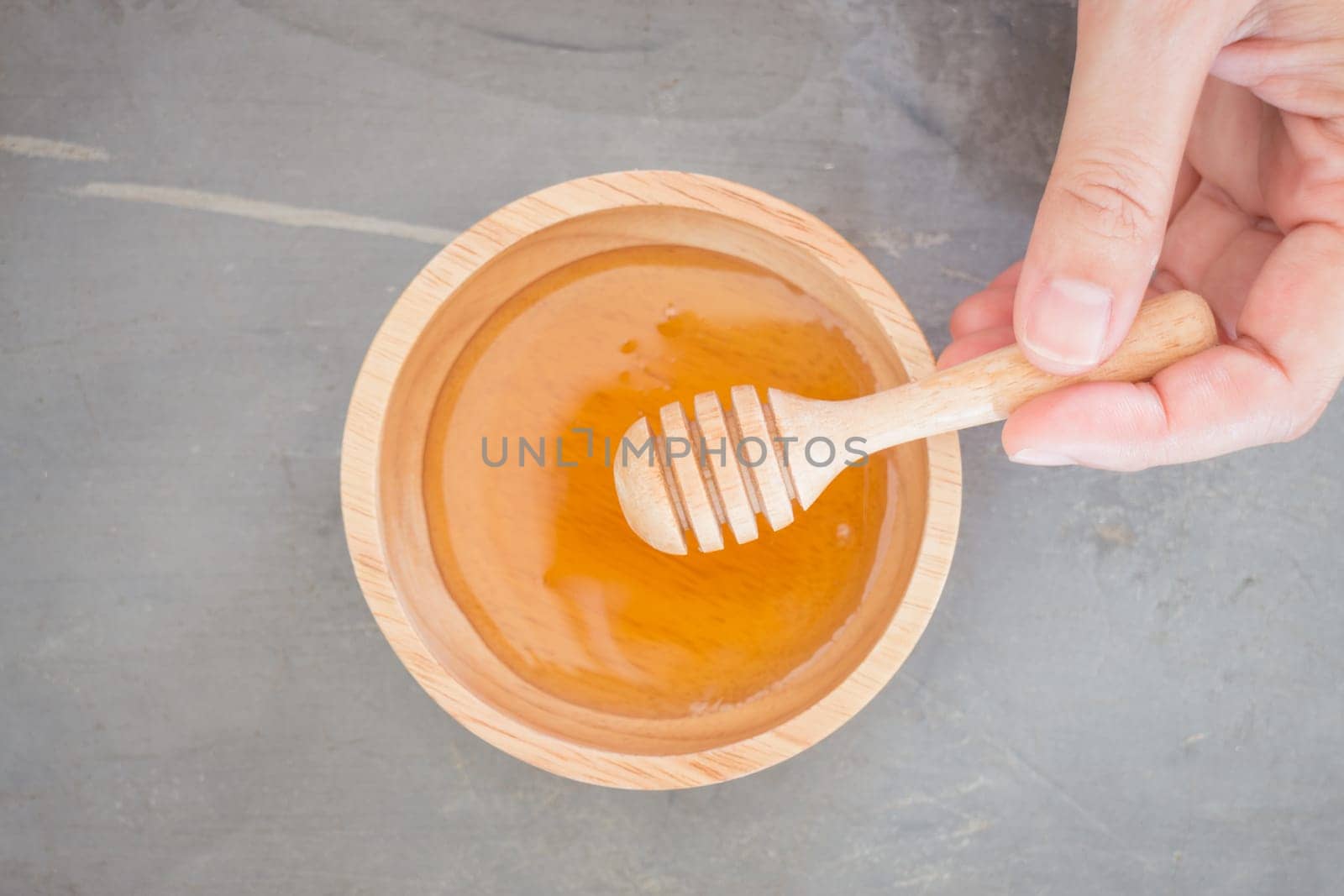 Hand on honey dipper top view, stock photo