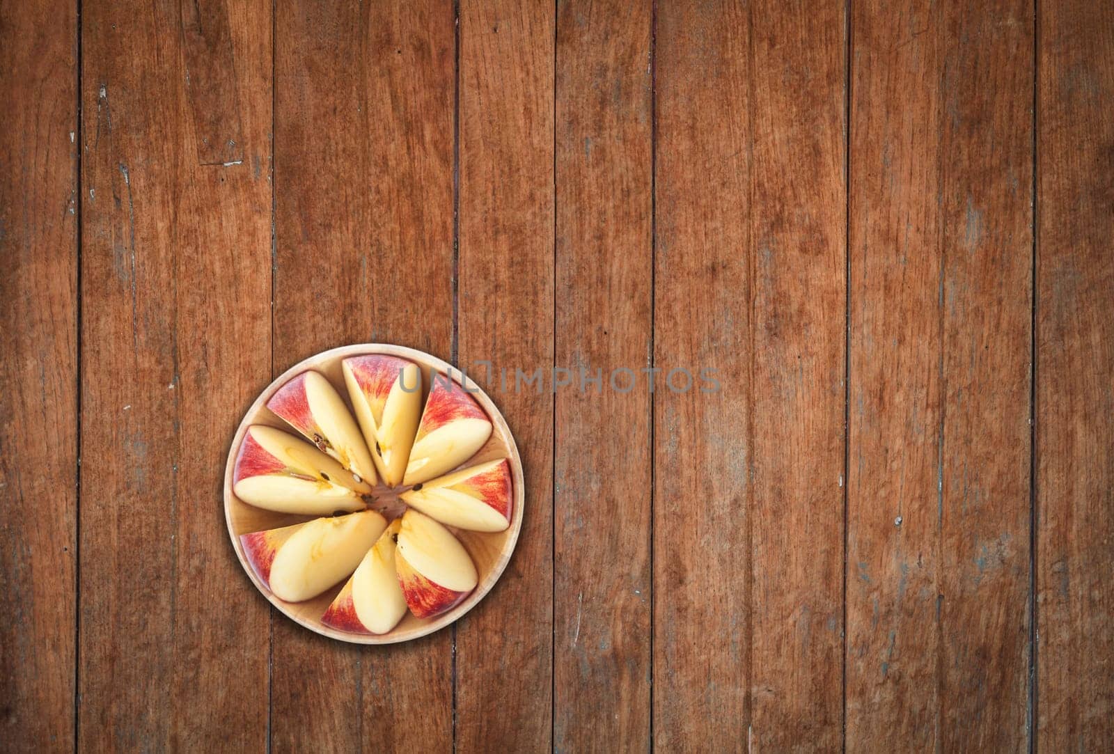 Top view of sliced apple on wooden background, stock photo