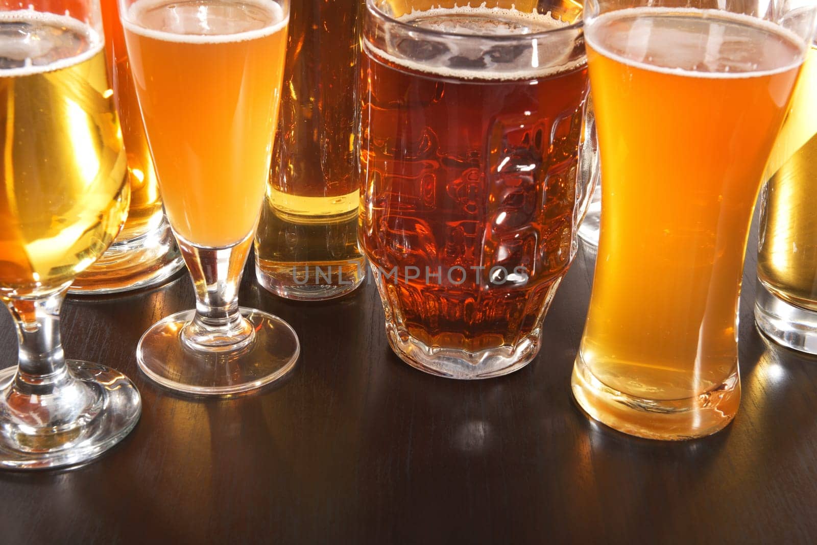 Many different beer glasses with different beer from all over the world