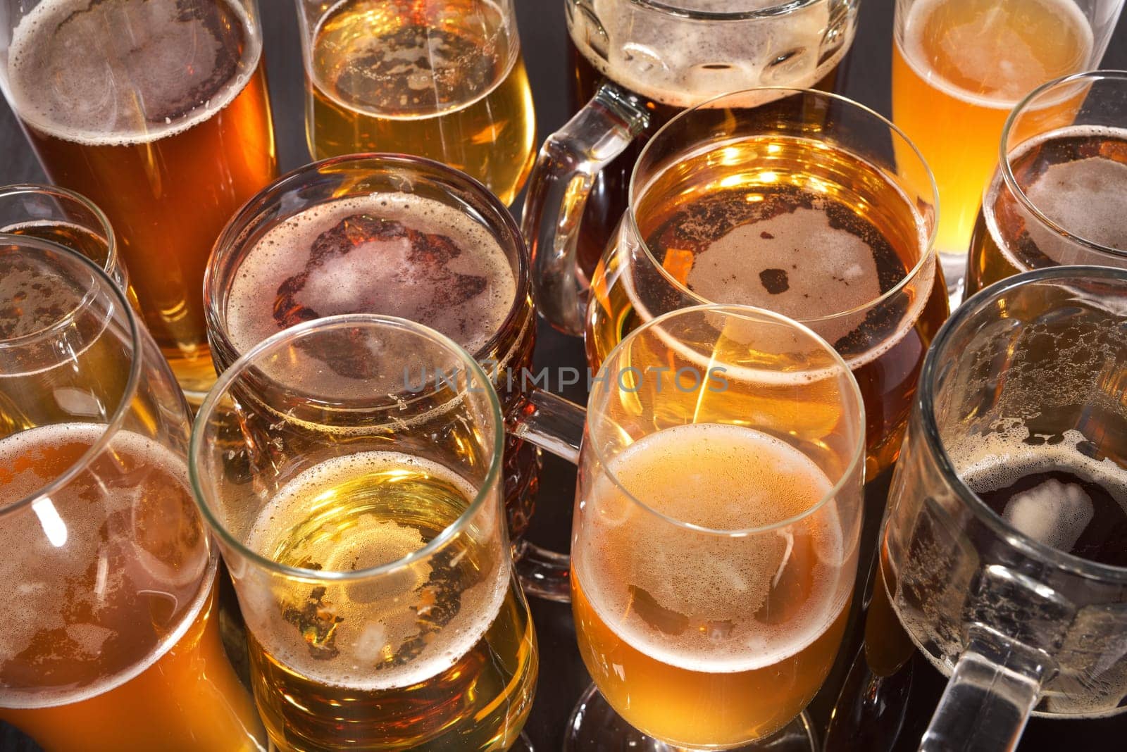 Many different beer glasses with different beer from all over the world