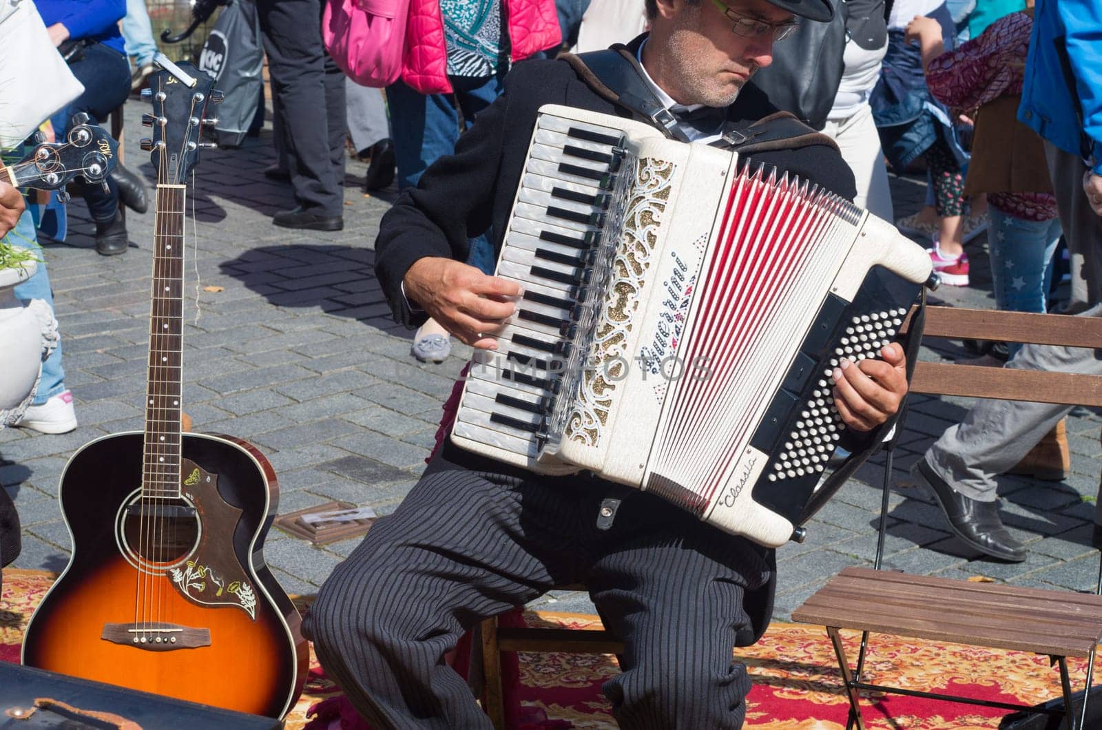 street artist playing his guerrini accordeon in the streets of zutphen, netherlands