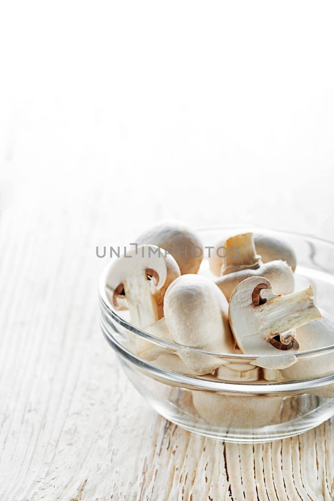 Fresh mushrooms champignons on a wooden background.
