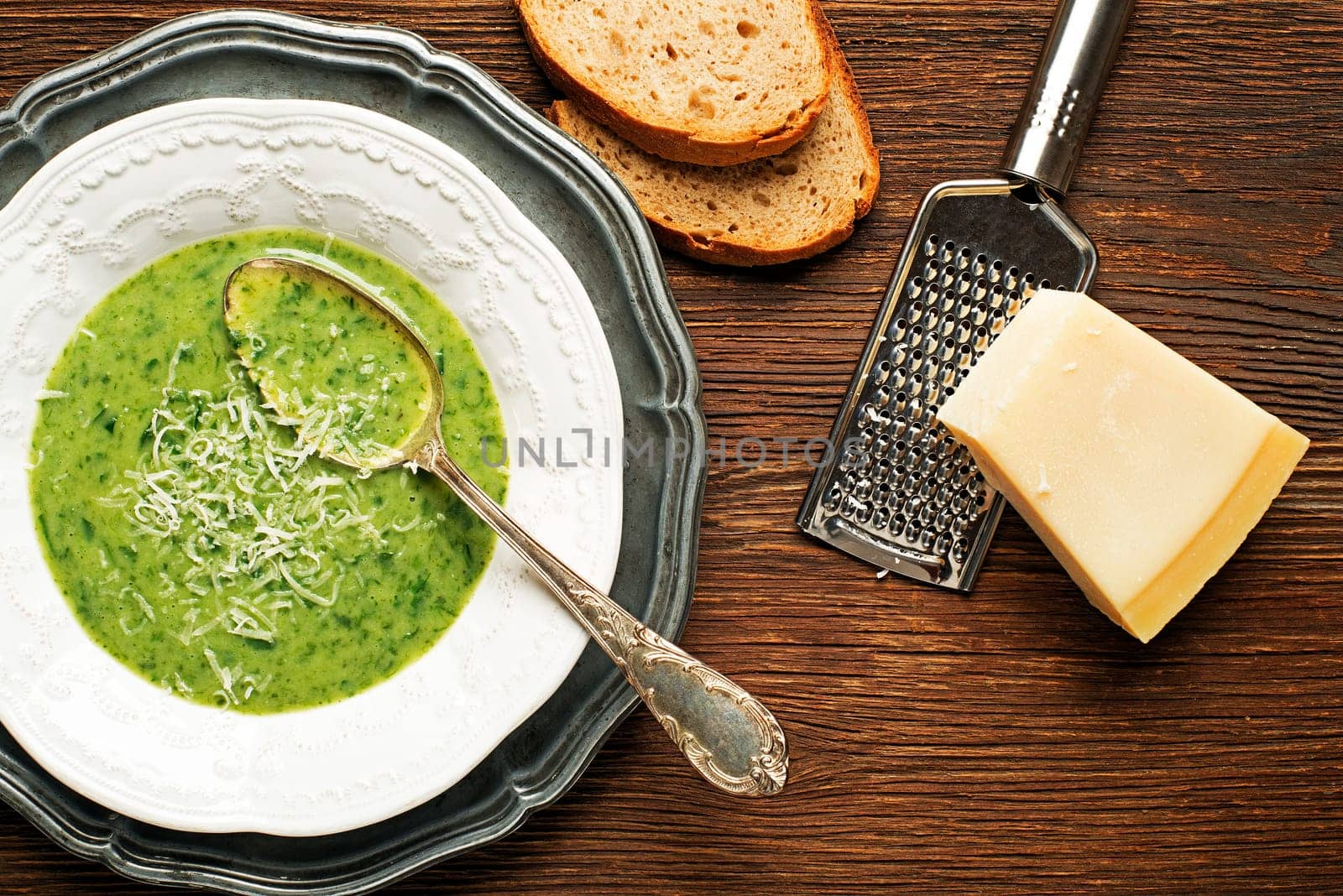 Fresh green soup on wooden background overhead shoot.