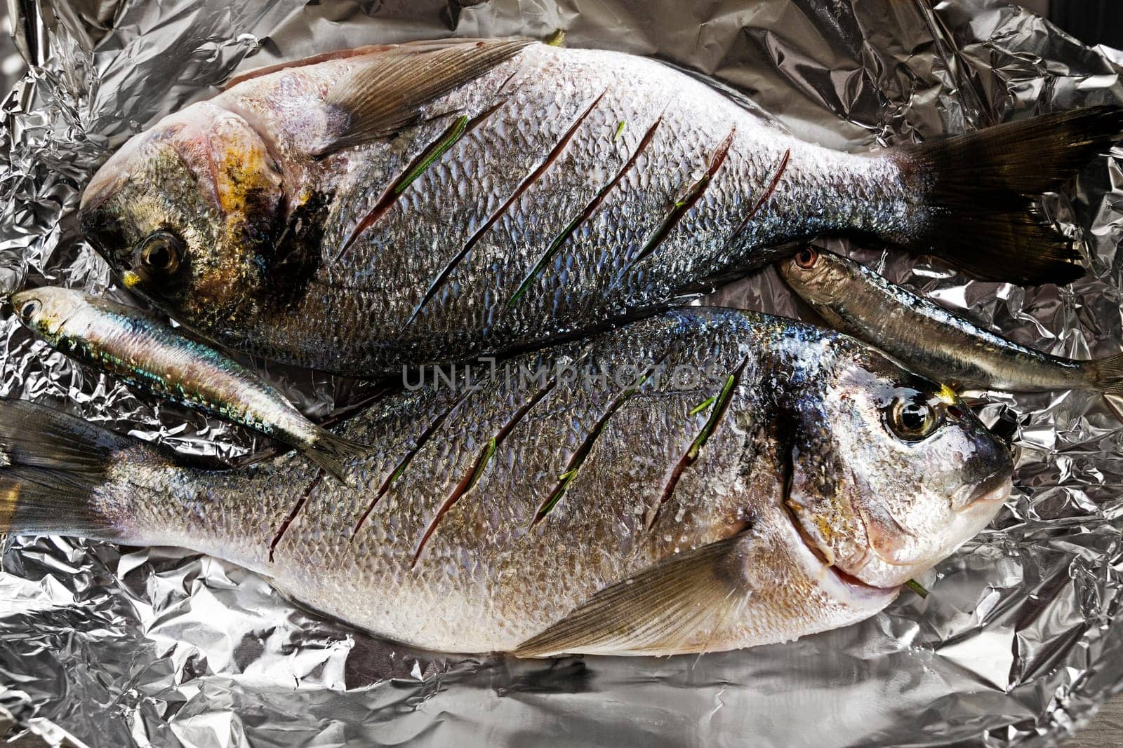 Delicious fresh raw gilthead with herbs. Culinary healthy cooking.