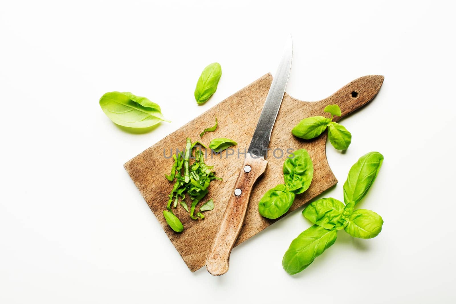 Fresh basil leaves on white background close up.