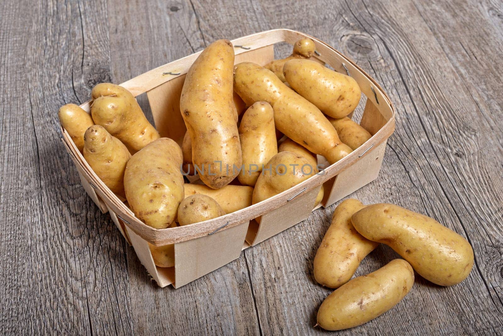 small potatoes on wooden background .