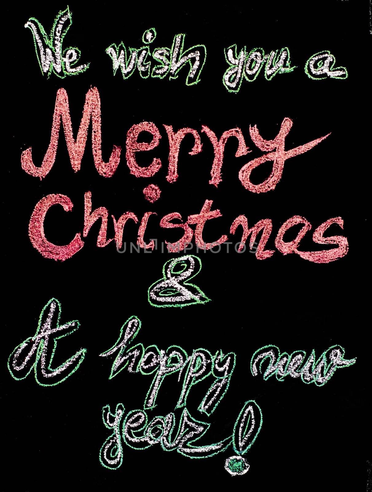 We wish you a Merry Christmas and a happy new year, hand writing with chalk on blackboard, vintage concept