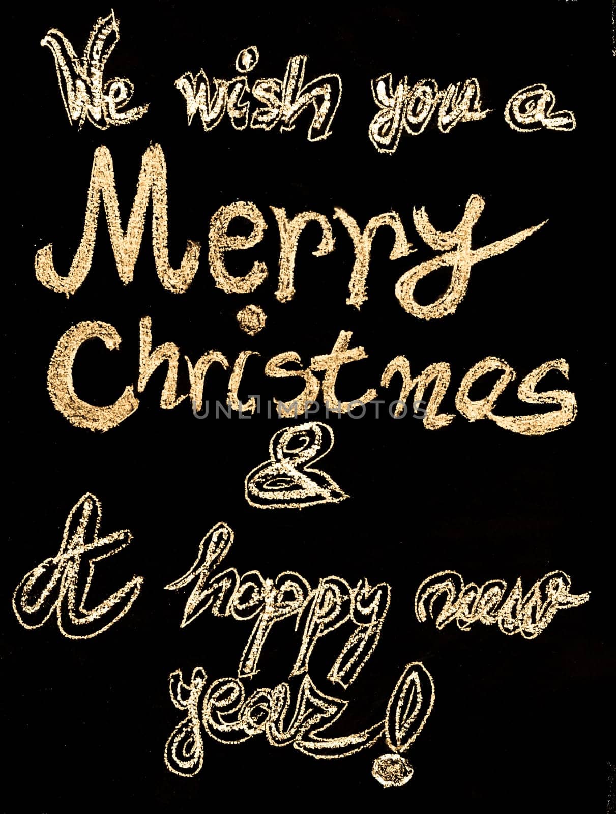 We wish you a Merry Christmas and a happy new year, hand writing with chalk on blackboard, vintage concept