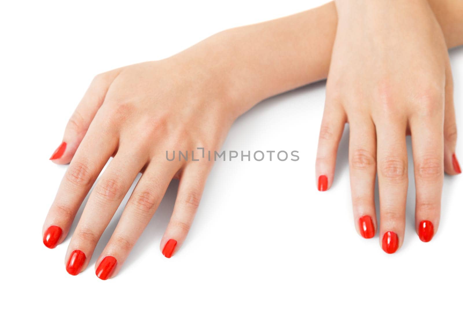 Women's hands with beautiful well-groomed fingers and red nail polish wellness beauty spa close up isolated on white background