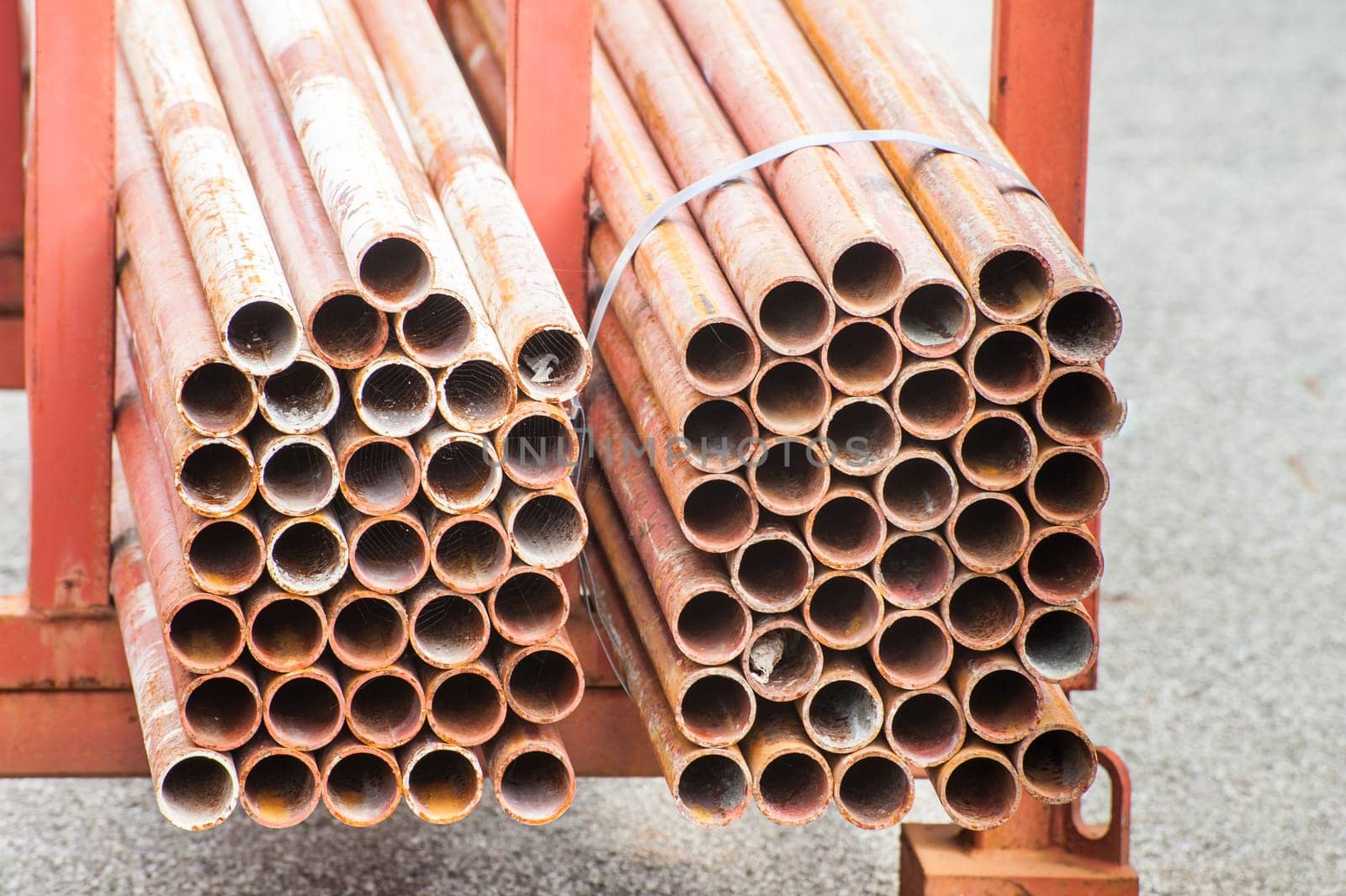 Stack of steel pipes for scaffolding in stock.