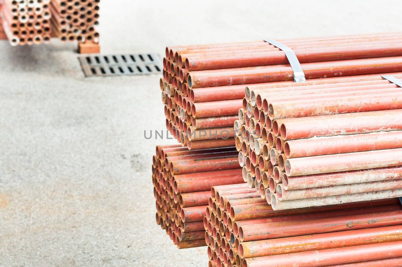 Stack of steel pipes for scaffolding in warehouse