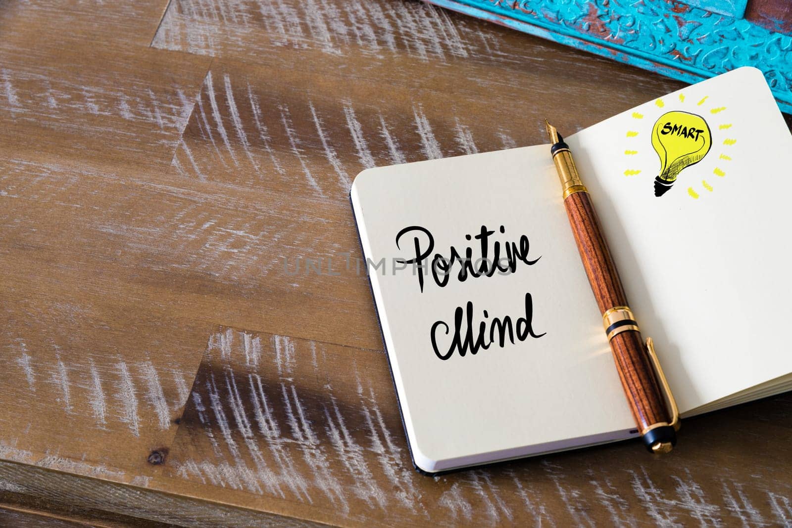 Handwritten text Positive Mind with fountain pen on notebook. Concept image with copy space available.