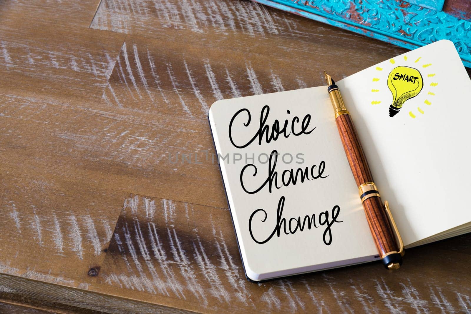 Handwritten text Choice, Chance, Change with fountain pen on notebook. Concept image with copy space available.