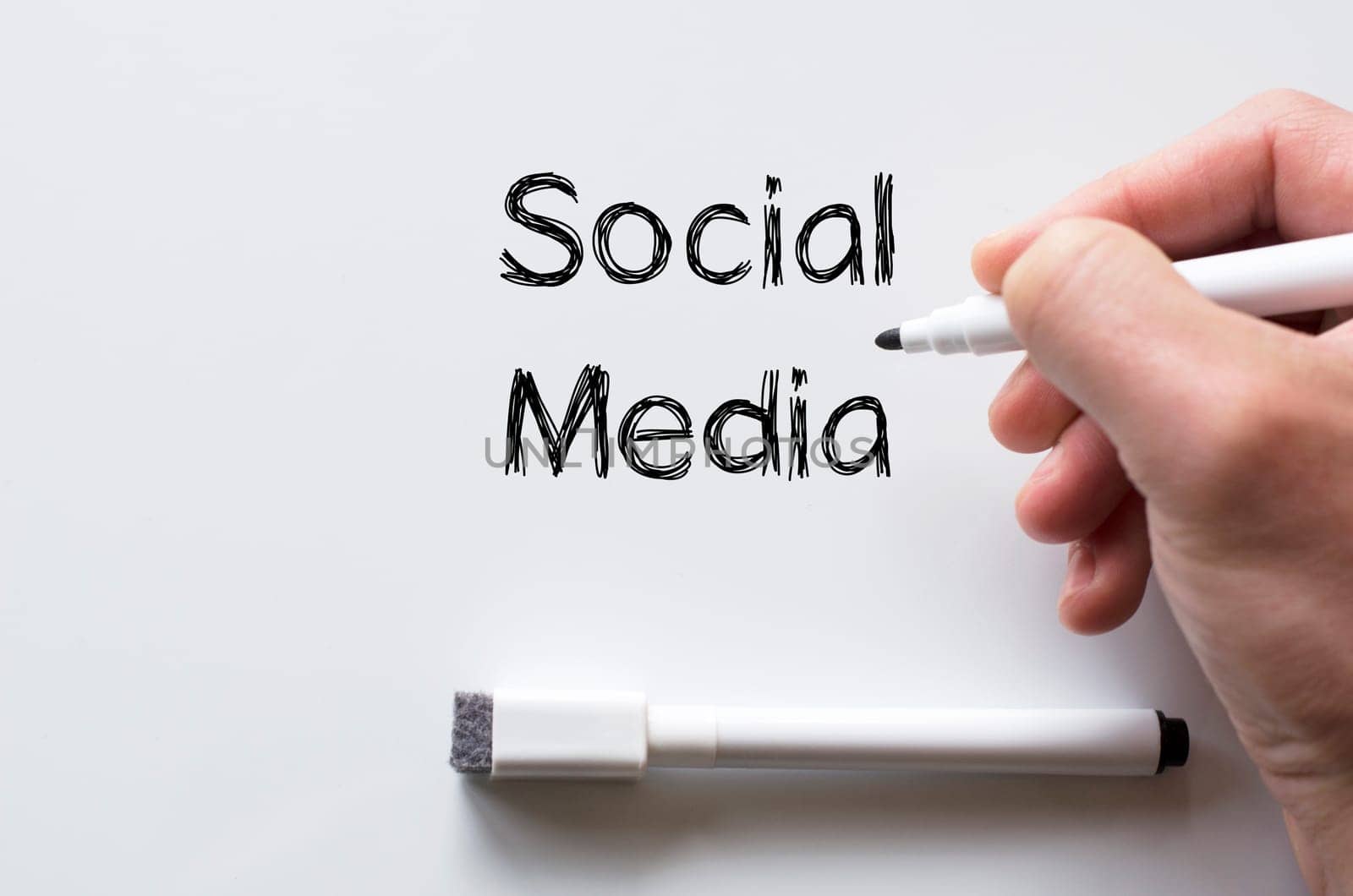 Human hand writing social media on whiteboard