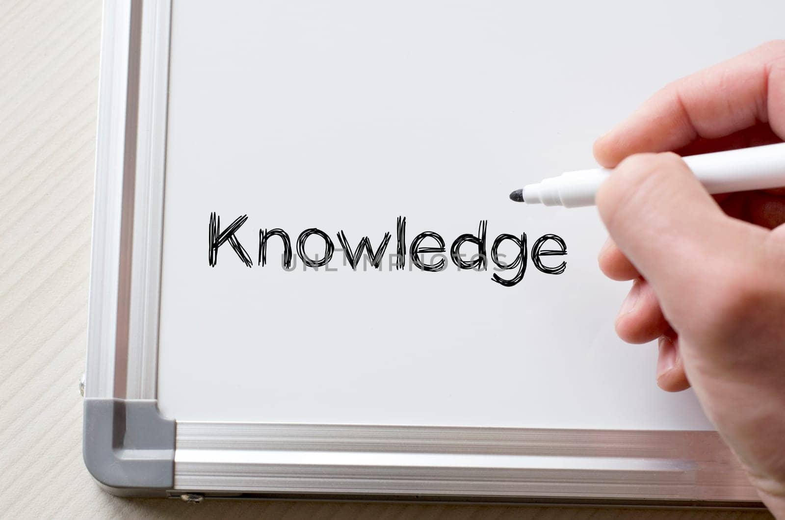 Human hand writing knowledge on whiteboard