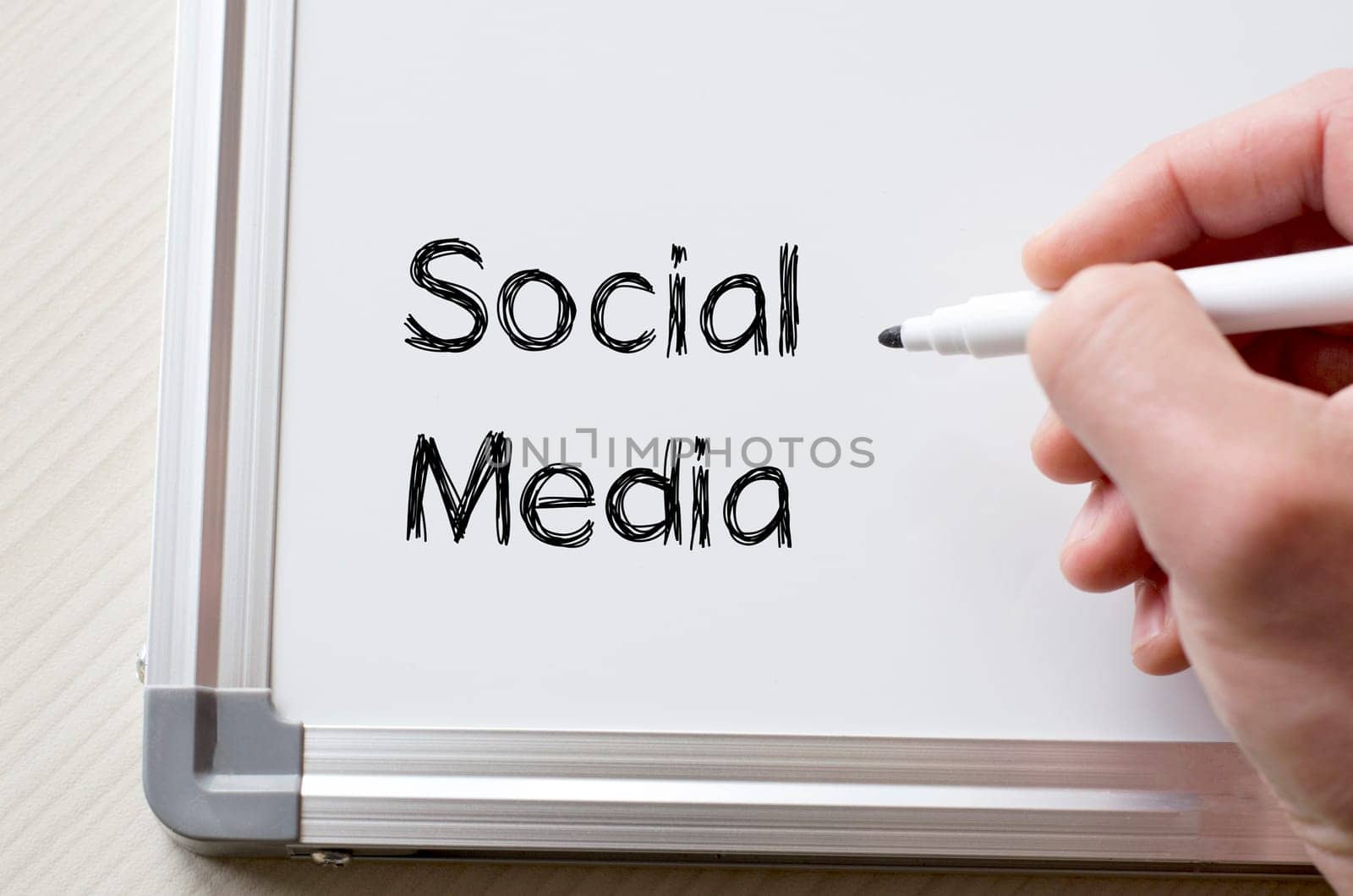 Human hand writing social media on whiteboard