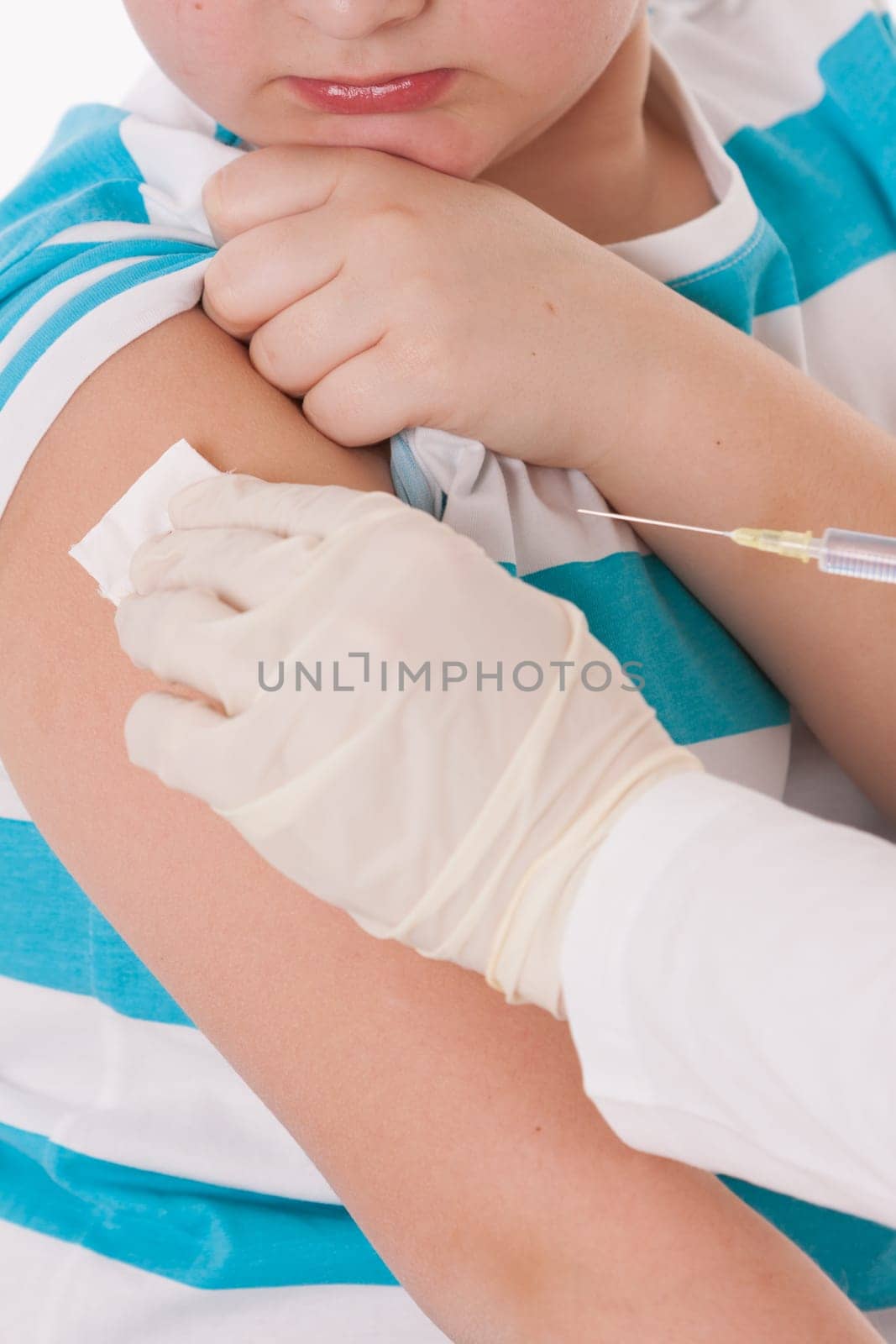 Doctor giving a child injection in arm on isolated image.
