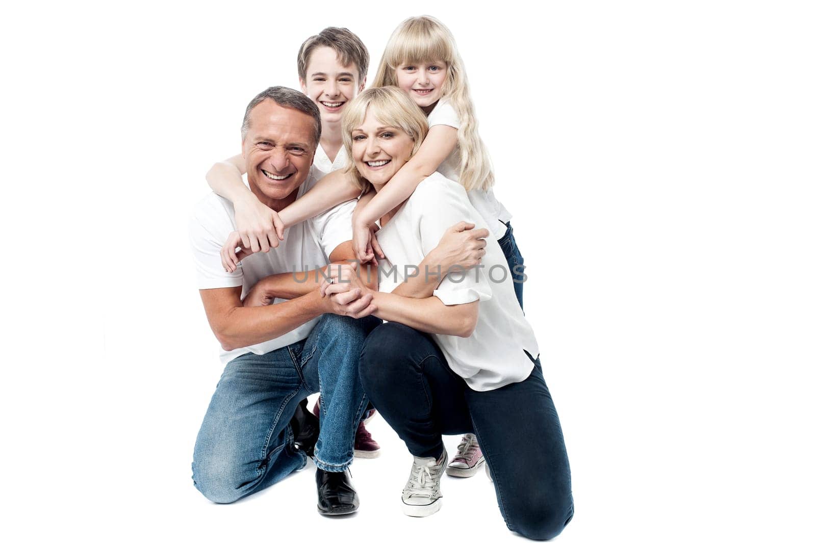 Parents giving piggyback ride to their son and daughter.