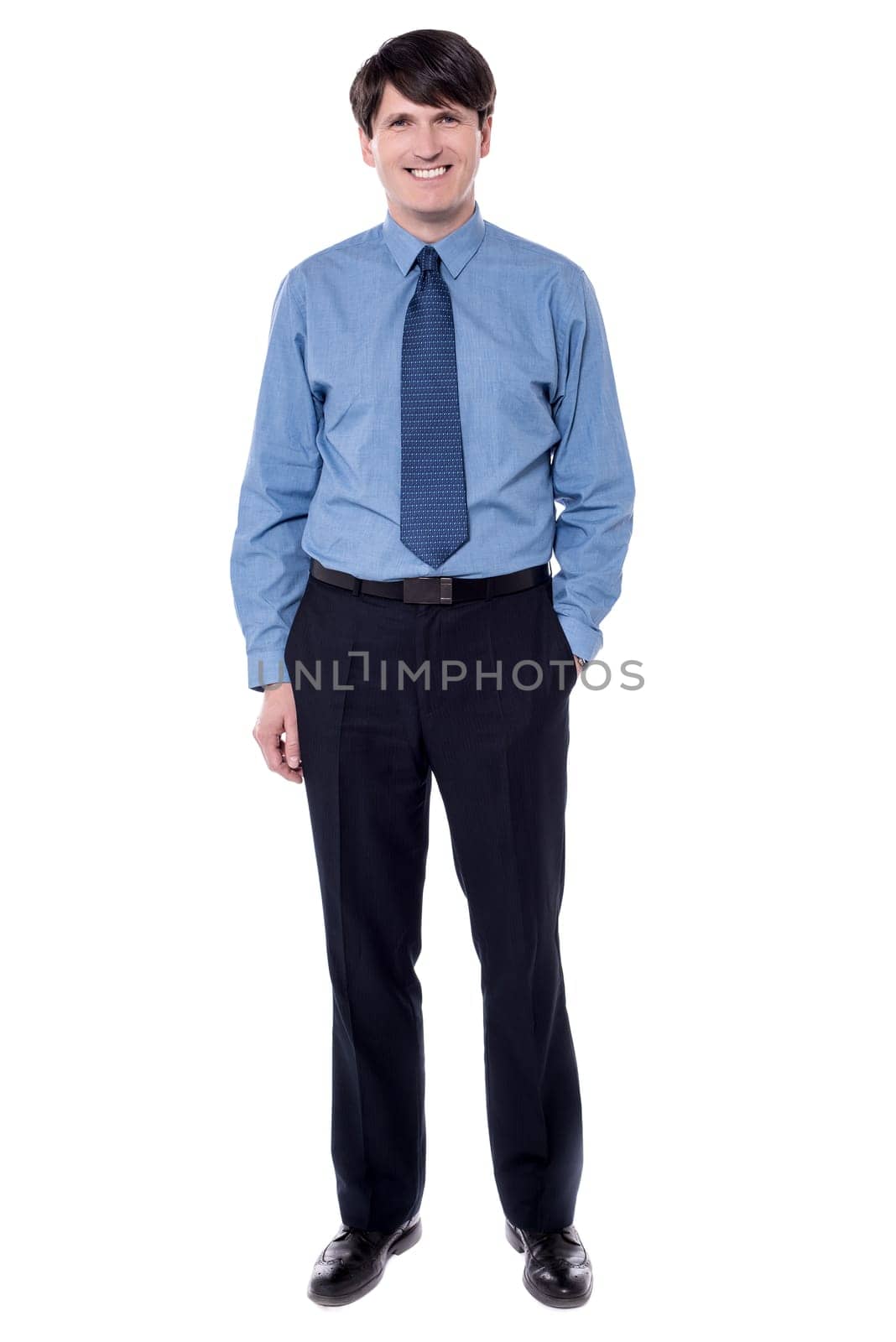 Full length image of businessman standing with his hand in pocket.