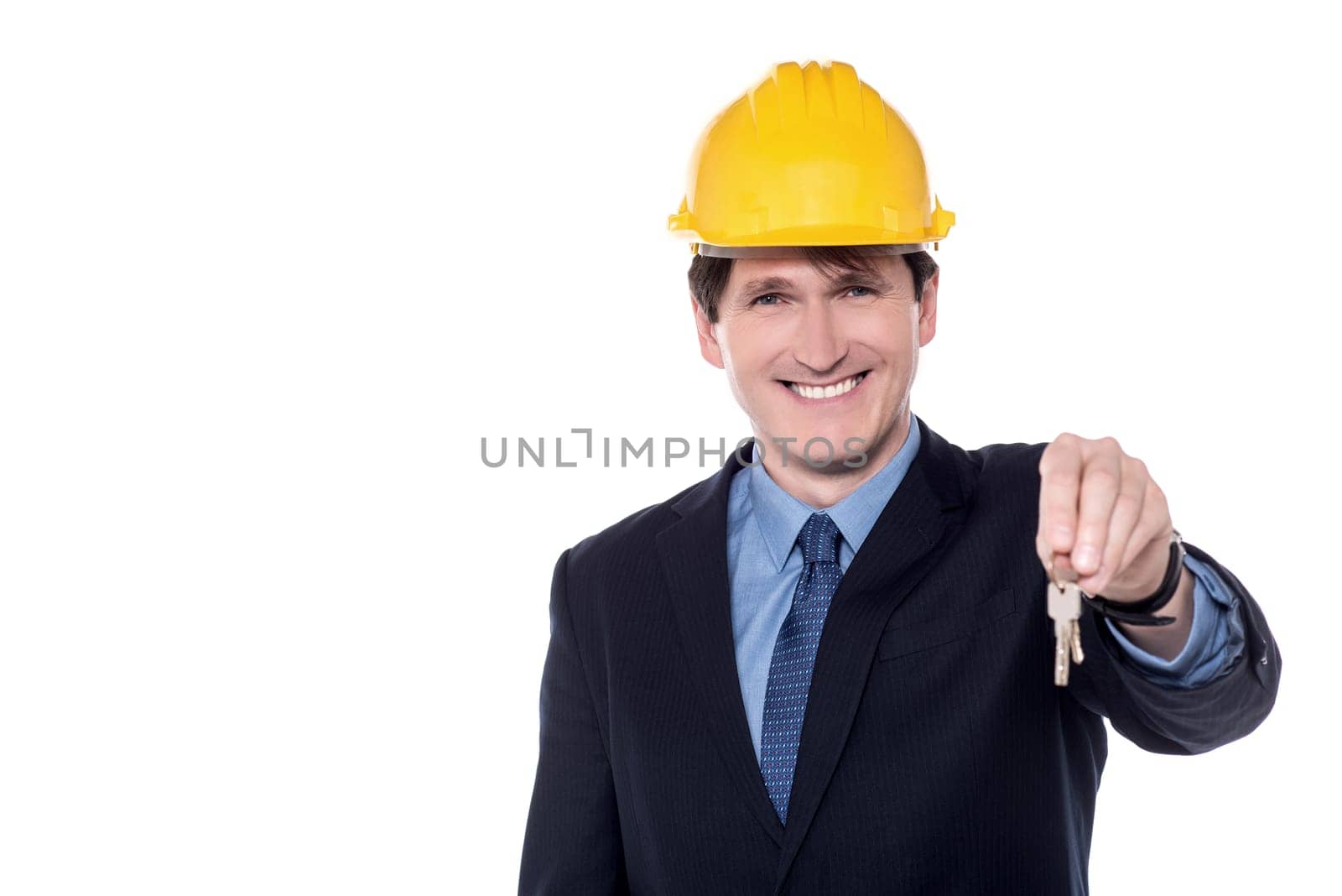 Smiling Male architect offering a new house key