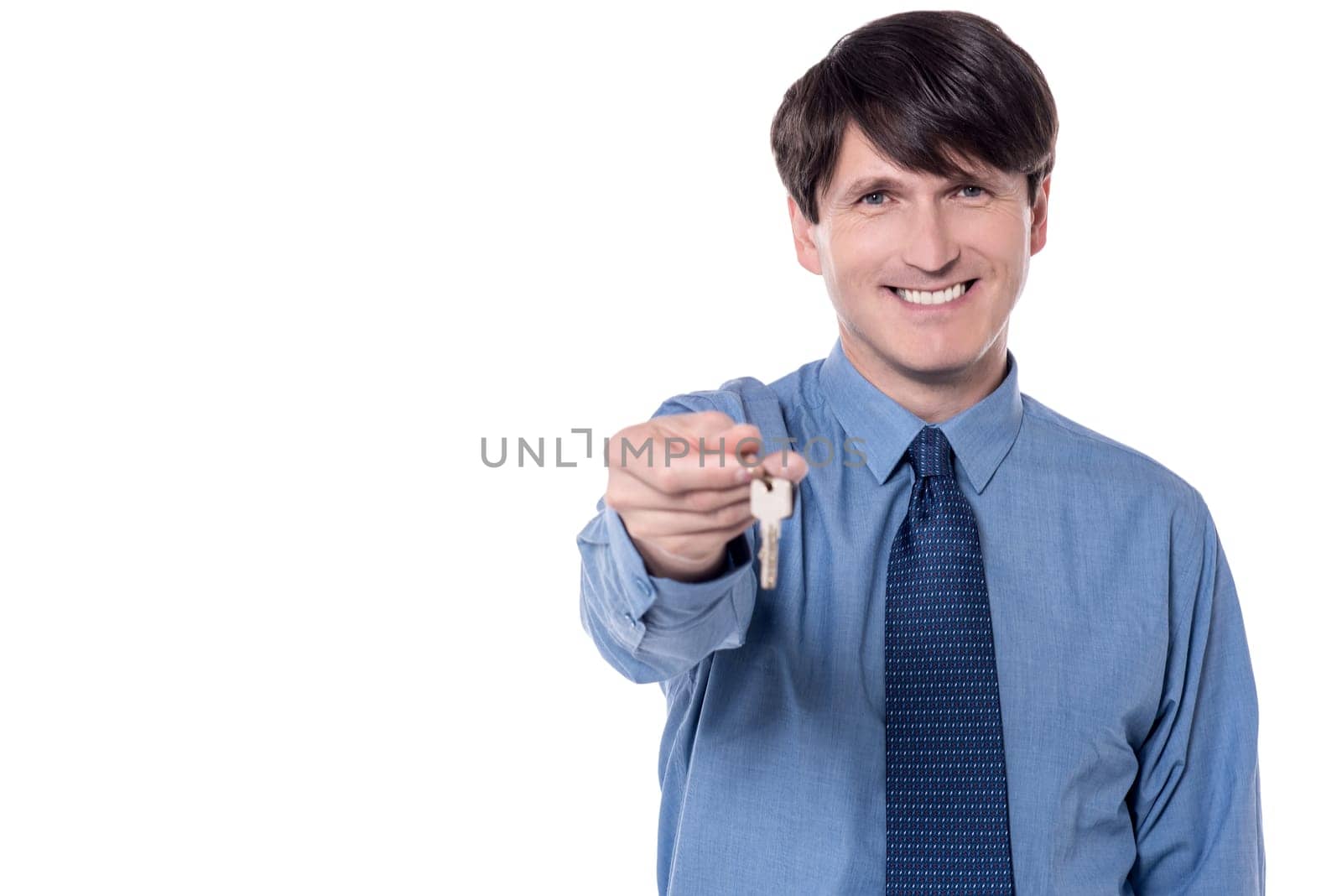 Middle aged businessman holding a house key.