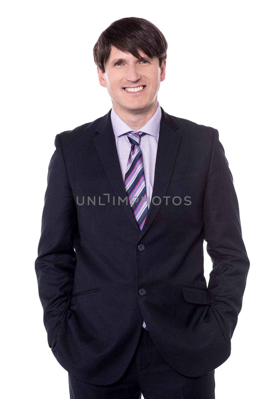 Friendly and confident businessman looking at camera and smiling.