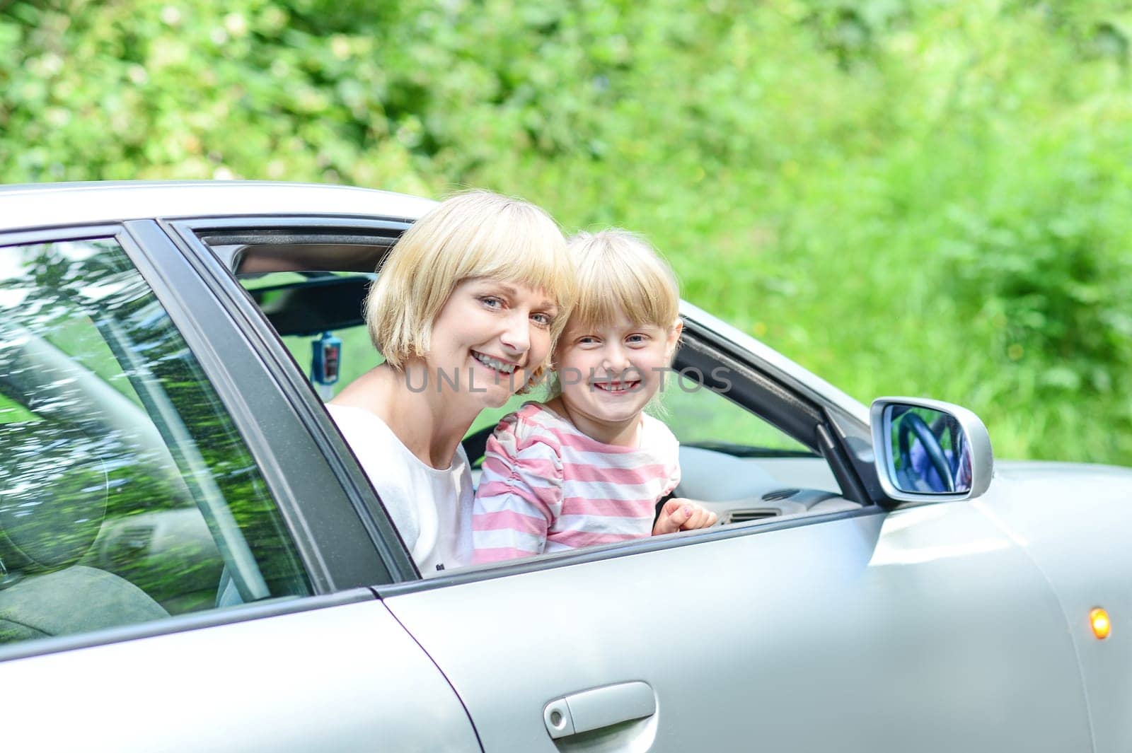 Family vacation. Mom with her child in car trip.