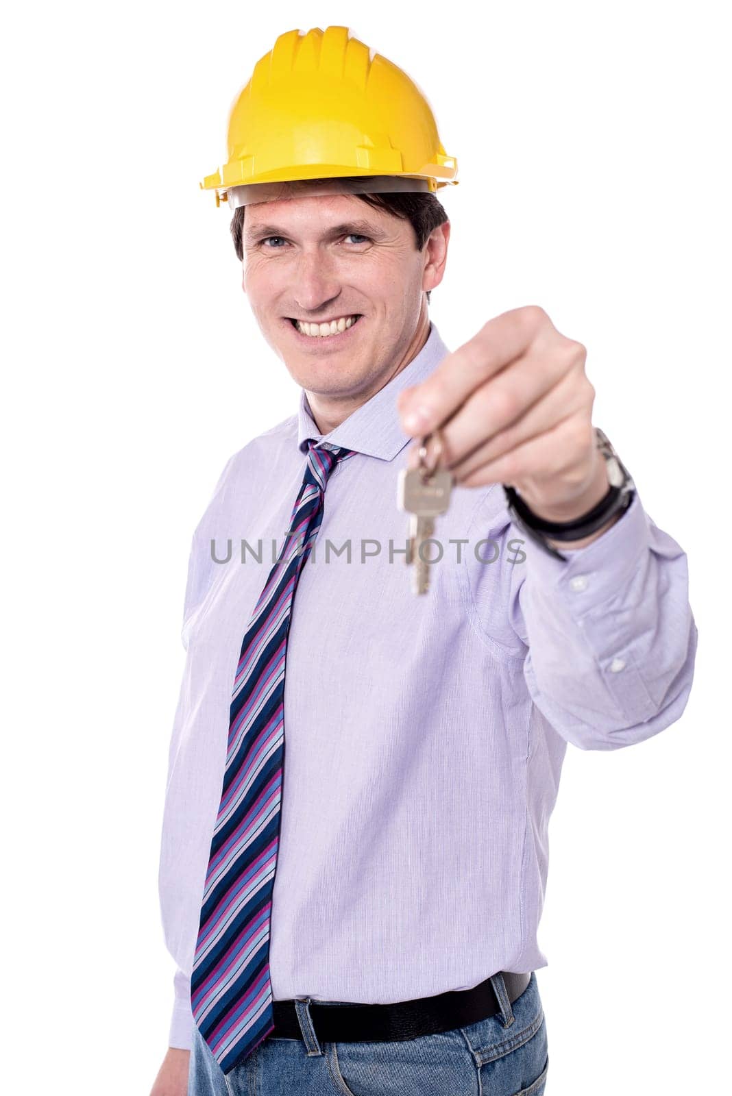 Male architect holding house key over white