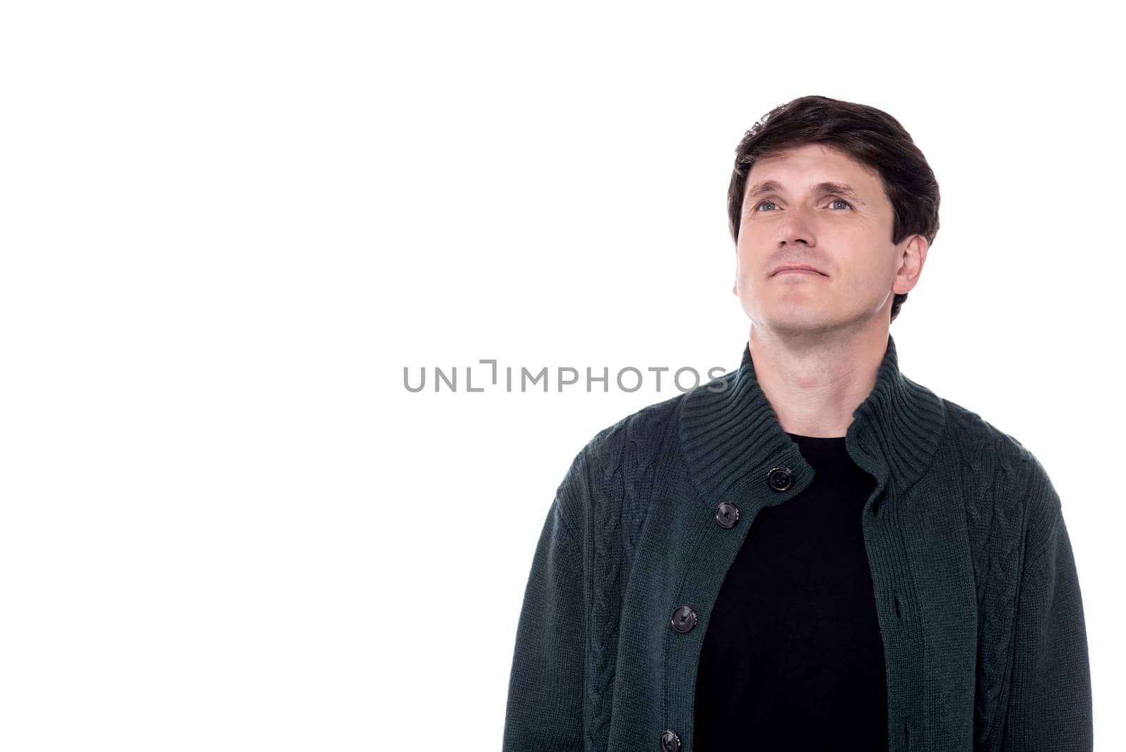 Casual man in knitted wear looking away.