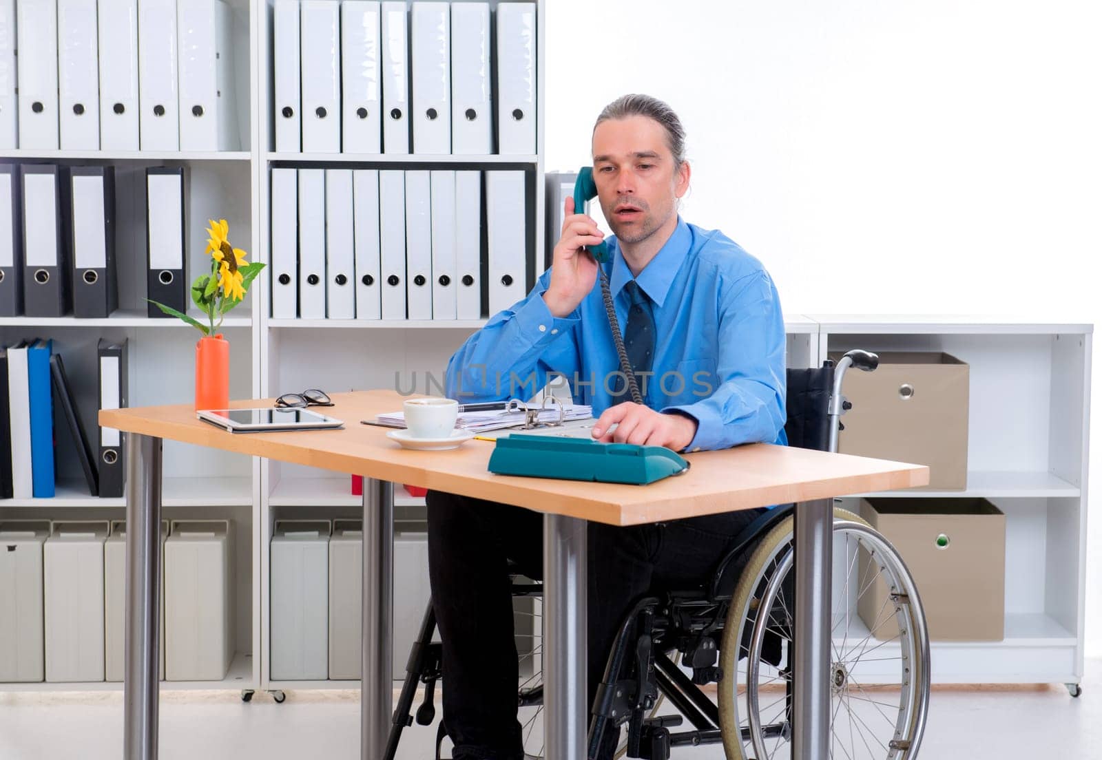 disabled business man in wheelchair is calling