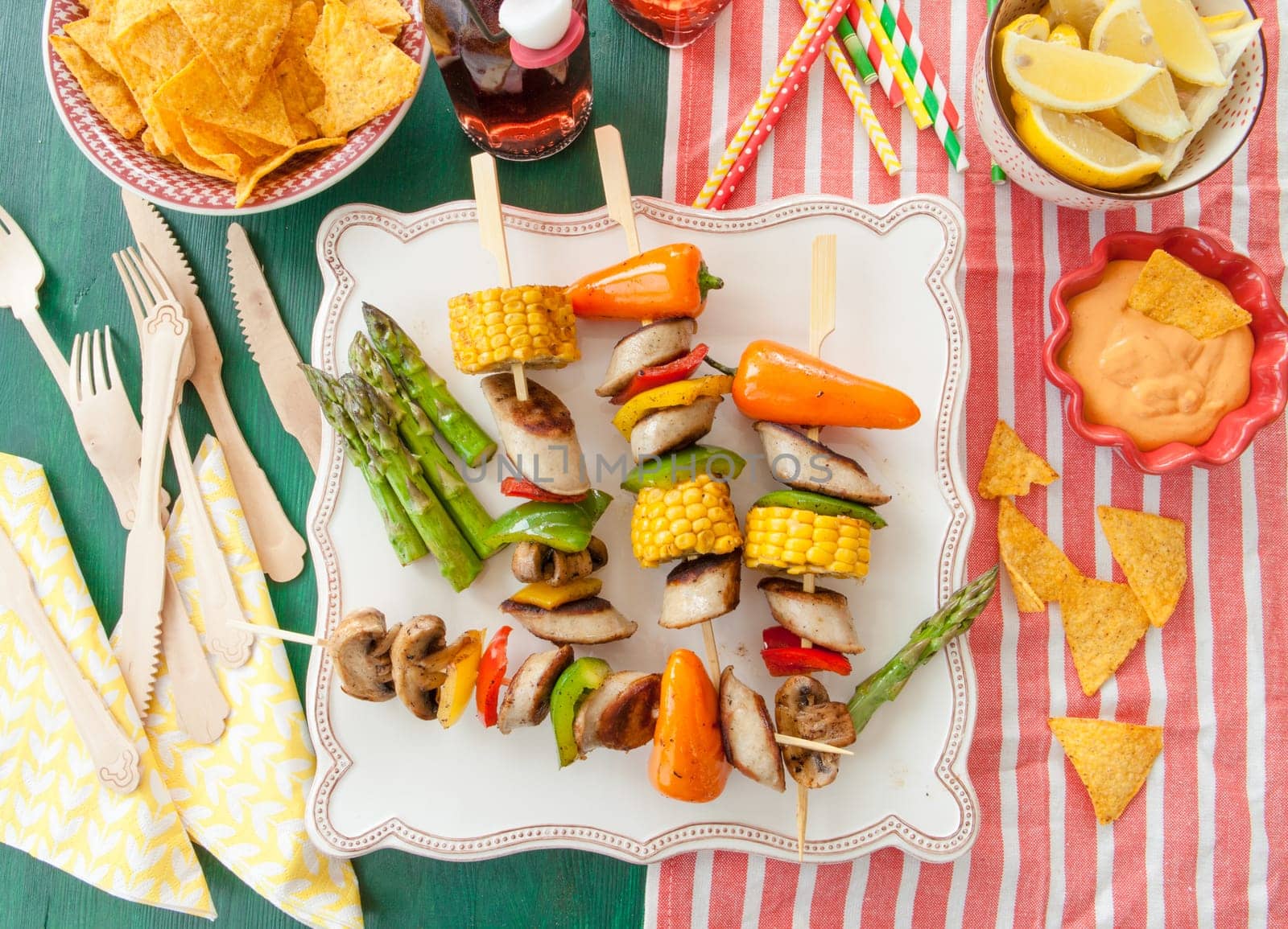 Colorful grilled skewers with fresh vegetables and bratwurst