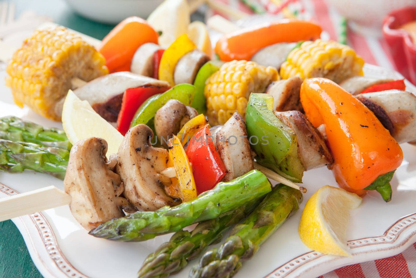 Colorful grilled skewers with fresh vegetables and bratwurst