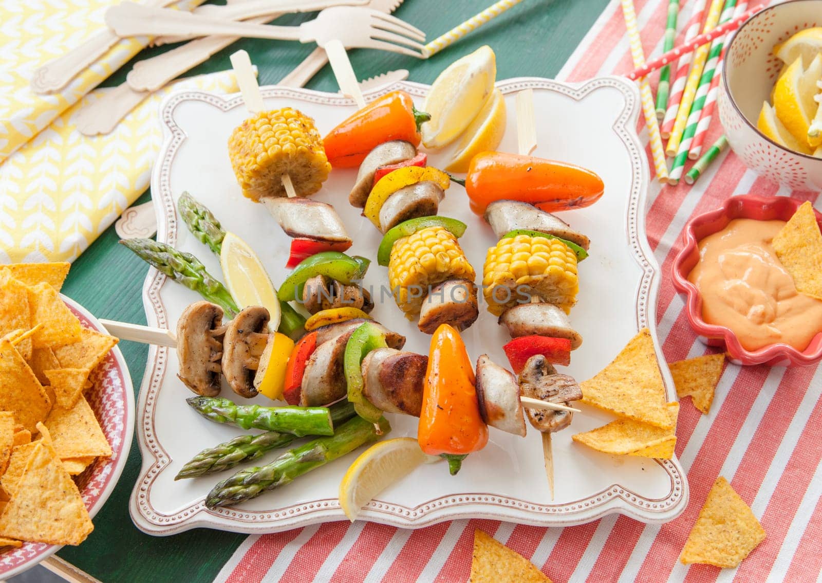 Colorful grilled skewers with fresh vegetables and bratwurst