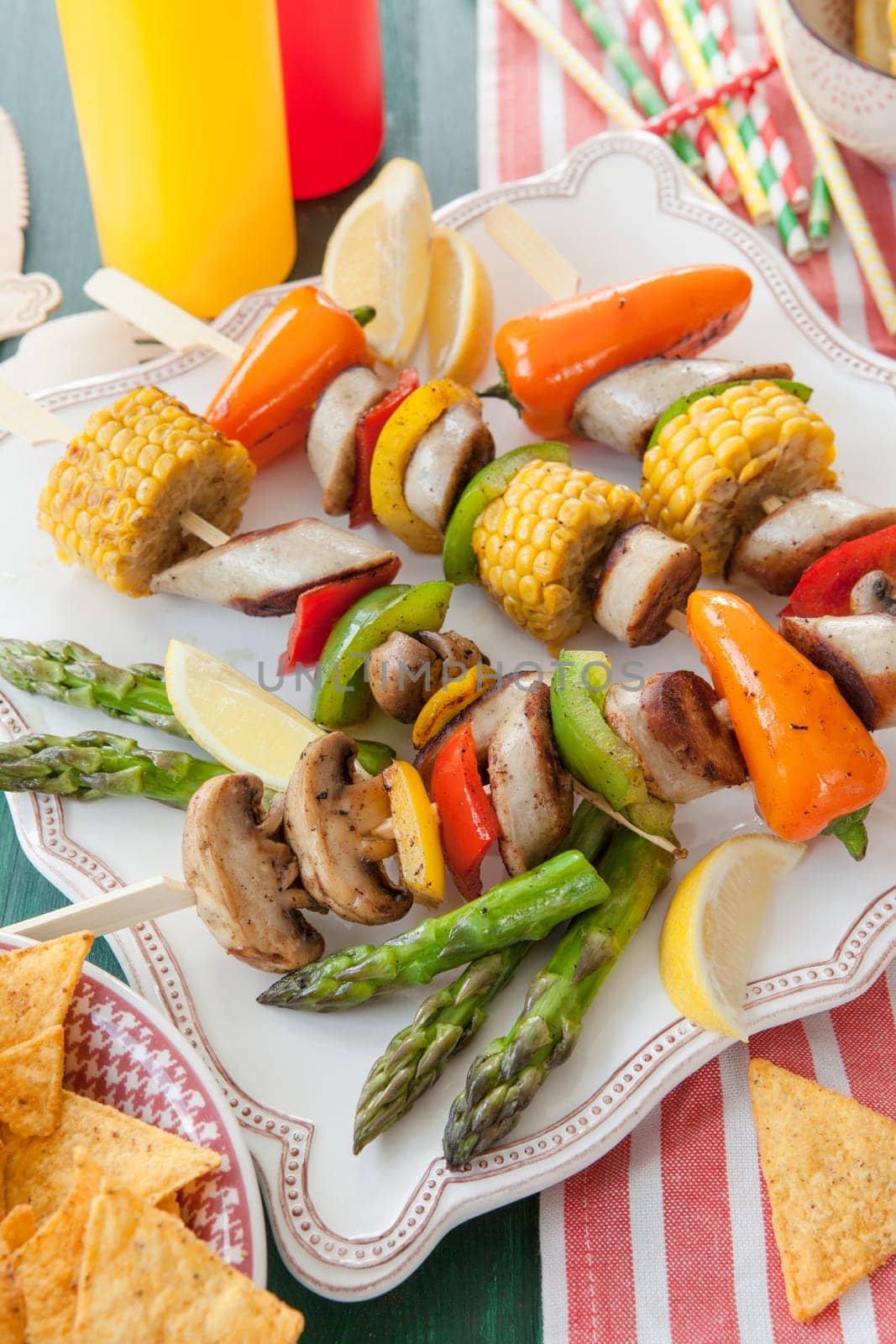 Colorful grilled skewers with fresh vegetables and bratwurst