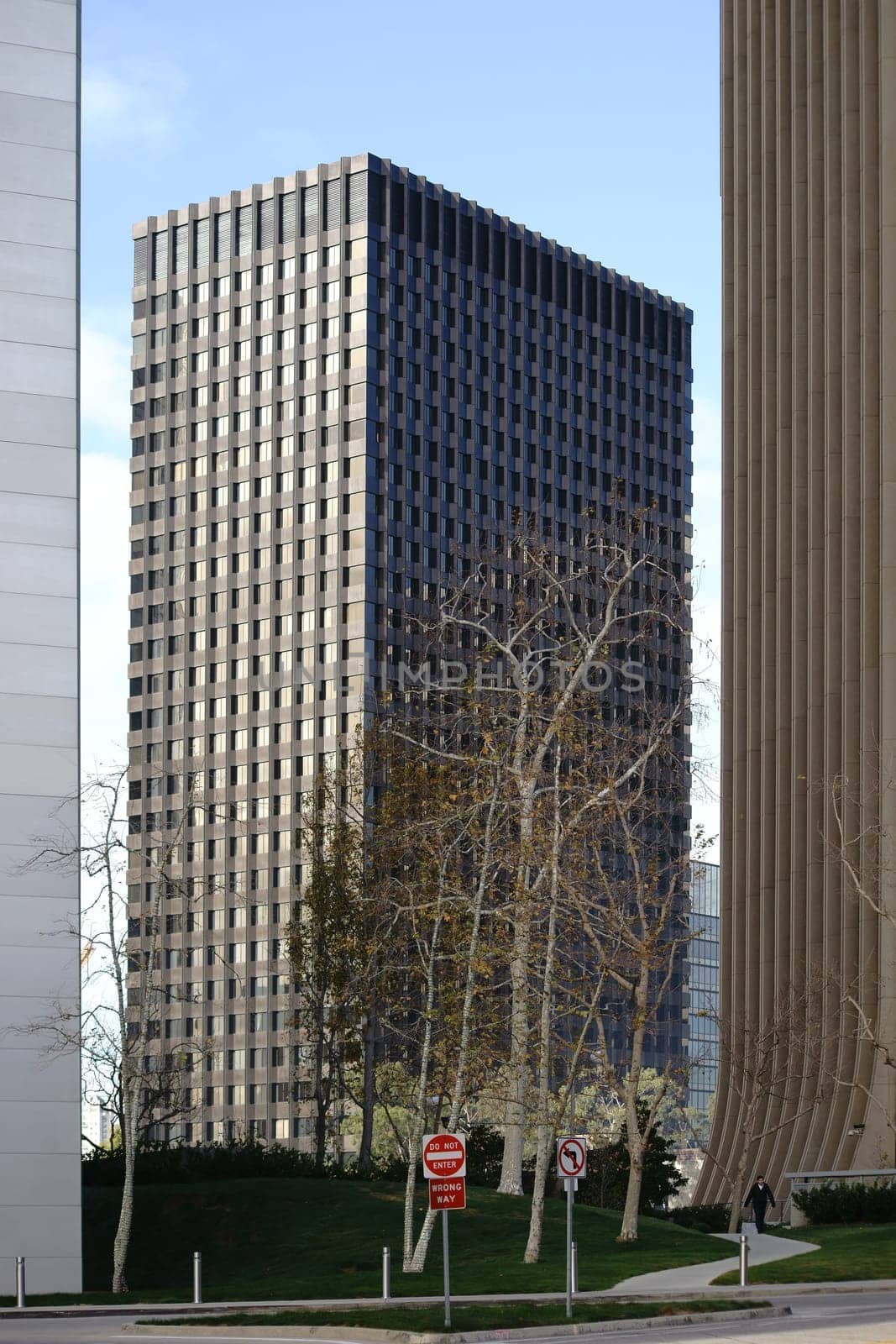 Los Angeles,United States - December 27,2015: A passerby walks between different skyscrapers along a path in the city center on December 27,2015 in Los Angeles.