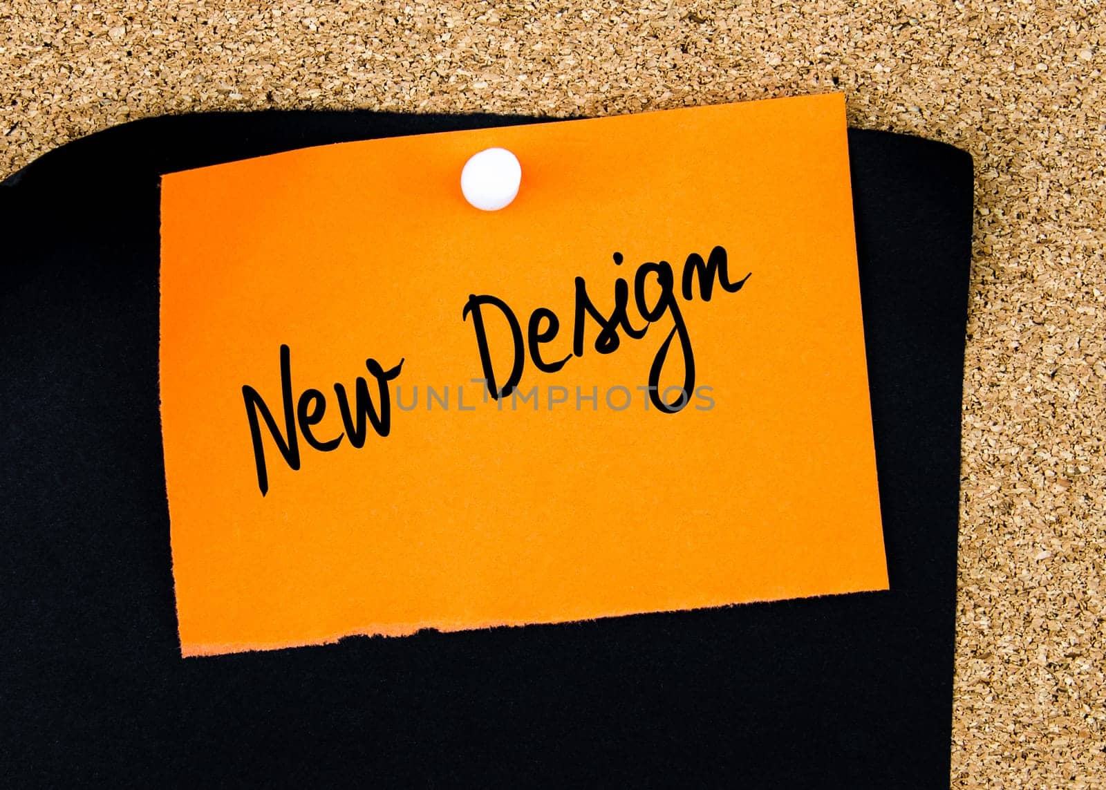 New Design written on orange paper note pinned on cork board with white thumbtacks, copy space available