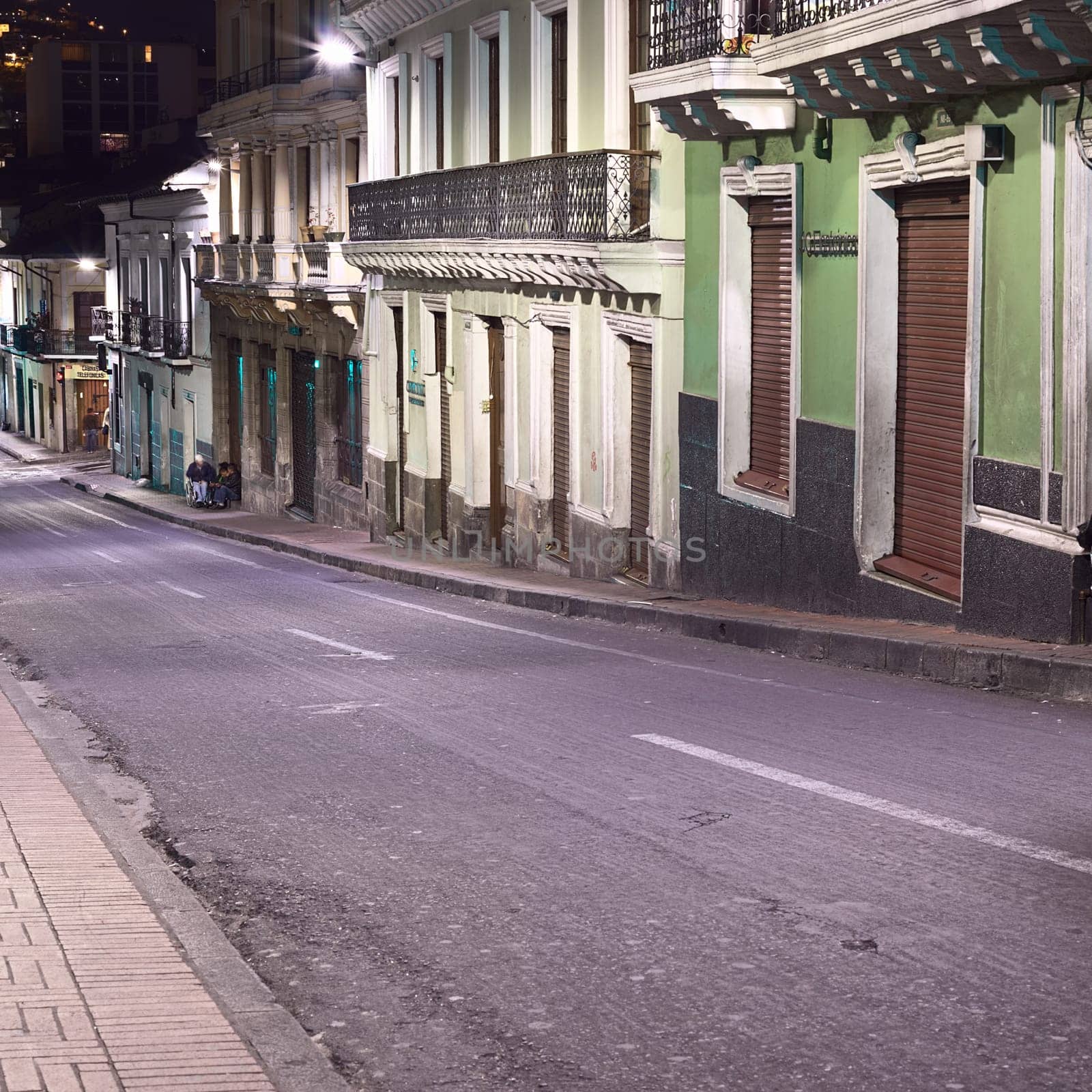 QUITO, ECUADOR - AUGUST 8, 2014: Venezuela street in the historic city center photographed at night on August 8, 2014 in Quito, Ecuador. Quito is an UNESCO World Cultural Heritage Site.